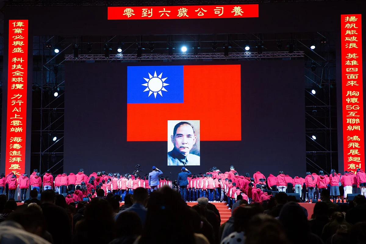 Foxconn's Terry Gou, and Young Liu salute the Taiwanese national flag and a portrait of revolutionary Sun Yat-sen, in Taipei, Taiwan, on Jan. 22, 2020. (Photographer: Ashley Pon/Bloomberg)