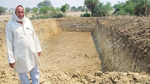 Rudra Pratap Mishra of Ganj village in Mahoba district, Uttar Pradesh, got a pond dug on his farmland, but is unsure about the durability of the structure (Photo: Kundan Pandey)