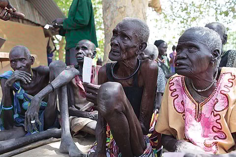In South Sudan where famine has been declared, elderly women listen to news about possible assistance. Amid the worsening situation, vulnerable people queue up for food distribution programmes. Many of them are old and suffer from ill health. In Nyal, Panyijar County, people take the help of canoes to reach food camps for registration (Credit: Bruno Bierrenbach Feder/Oxfam)