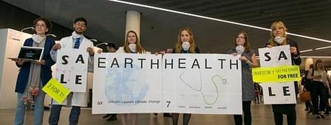 Members of civil society hold a demonstration to raise awareness about the health implications of climate change
Credit: IISD Reporting Services