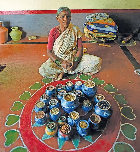 Paramma, a traditional seed saver of Telangana, showcases different types of indigenous seeds kept at her house (Photo: Adithyan)