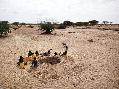 A group of young girls dig up a dried riverbed to get water in Turkana county in northern Kenya (Photo: Jitendra)
