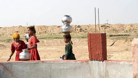 Young girls at a well in Gujarat, which is already facing a water scarcity. Credit: Mark Charmer/The Third Pole