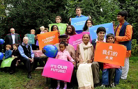 Nobel Laureate Archbishop Desmond Tutu and former US President James Earl Carter with kids displaying placards warning about climate change Credit: Flickr