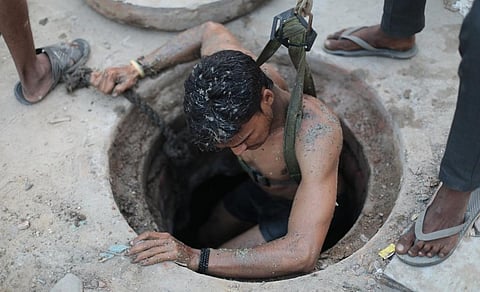 Johny, a 29-year-old manual scavenger, comes out after cleaning a septic tank in Ghaziabad. Credit: Vikas Choudhary