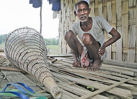 Holiram, Miri fisherman of the Mising community in Assam, says the ideal way to dry minnows is to spread it on the white river sand in the winter. But the Dhansiri river has changed its course so many times due to heavy siltation load that they now live on the embankments. (Credit: Dhruba Jyoti Dutta)