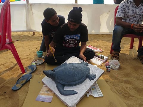 Children painting a turtle at the festival. Photo: Ashis Senapati