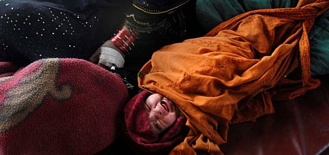 A newborn rests beside her mother at a hospital in Afghanistan. Photo: US Department of Defense