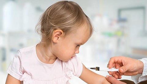 A doctor administering a vaccine to a child. Photo: Getty Images