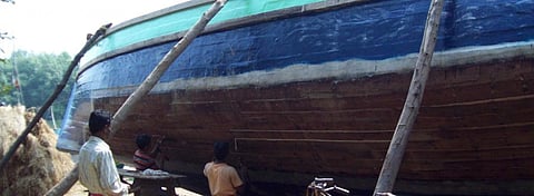 Carpenters repairing a fishing vessel in Kharinashi village. Photo: Ashis Senapati