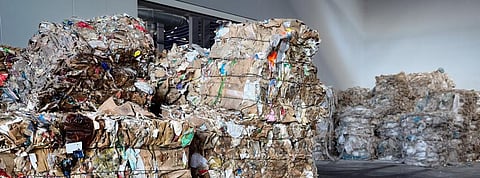 Used cardboard polyethylene and plastic pressed into bales at finished products warehouse. Photo: Getty Images