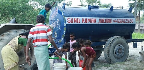 Villagers taking water from government-sponsored water tankers. Photo: DTE