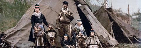A Sami family in front of their 'laavu' or traditional tent in Lapland. Photo: Wikimedia Commons
