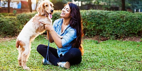 A woman with her pet dog. Photo: Getty Images