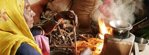 A woman cooking food on a chulha. Photo: CSE