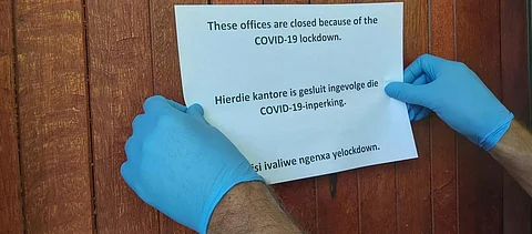 A sign being put up outside an office in South Africa after the lockdown was announced Photo: Engela Duvenage