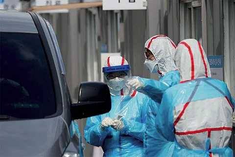 A drive-through
testing facility in
South Korea. Using
its experience from
the MERS outbreak
in 2015, the country
has not only set up a
huge infrastructure
for testing but also
kept them separate
from treatment
facilities to avoid the
spread of infection (PHOTO: REUTERS)
