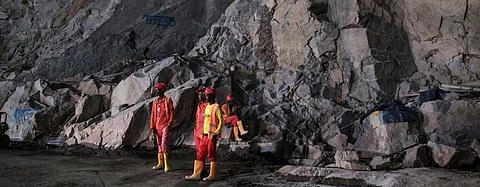 Construction workers stand next to rock wall at the Grand Ethiopian Renaissance Dam in Ethiopia on December 26, 2019. Photo: The Conversation