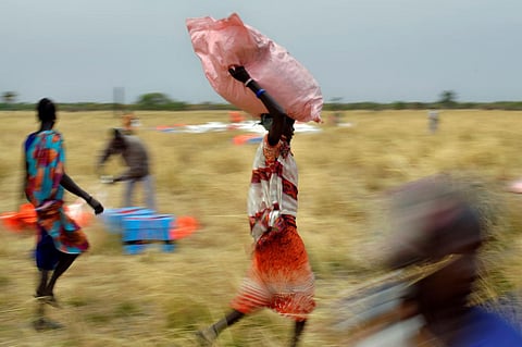 Villagers collect World Food Programme aid dropped from a plane Feb. 6 in South Sudan. Tony Karumba / AFP via Getty Images