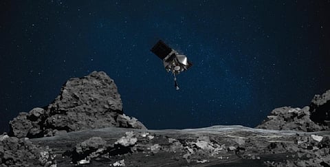 An artist’s rendering shows OSIRIS-REx spacecraft descending toward asteroid Bennu to collect a sample of the asteroid’s surface. Photo: NASA/Goddard/University of Arizona