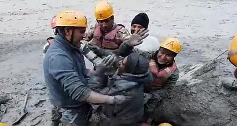 A screengrab of a video that showed ITBP men pulling out a labourer buried in the mud. Photo: Uttarakhand Police's Twitter Handle