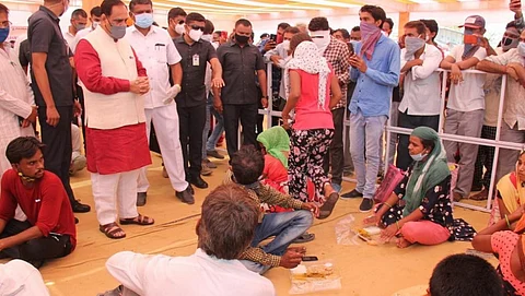Gujarat CM Vijay Rupani talks with relatives of COVID-19 patients during a visit to Junagadh Civil Hospital May 4. Photo: @vijayrupanibjp / Twitter