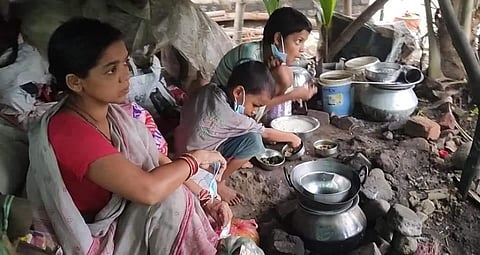 A woman with her two children in their damaged house in Kendrapara district, Odisha, a day after Cyclone Yaas struck. Photo: Ashis Senapati