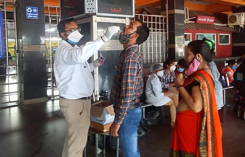 A patient being tested for COVID-19 at the New Delhi railway station during the second wave of the pandemic in India. Photo: Wikimedia Commons
