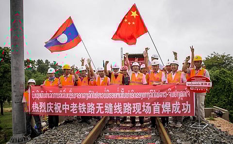 Chinese engineers pose after welding the first seamless rails for the China-Laos railway in Vientiane, Laos, June 18, 2020. Kaikeo Saiyasane/Xinhua via Getty Images