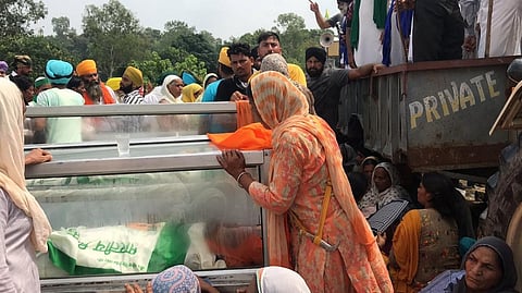 A family member mourns near the body of a dead farmer in Lakhimpur-Kheri. Photo: @alim_jafri / Twitter