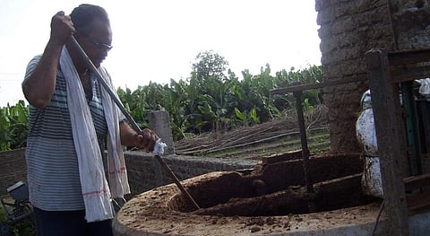 A Vidarbha farmer stirs slurry in his biogas plant. Photo: Aparna Pallavi / CSE