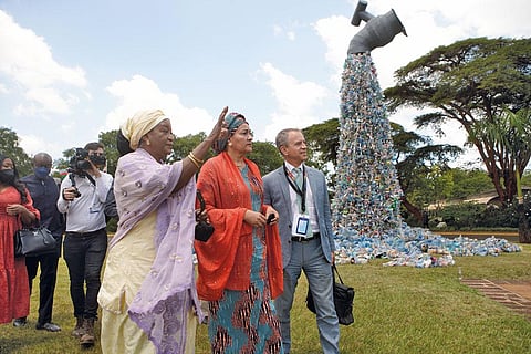 Officials walk past an artwork at the fifth UN Environment Assembly in Nairobi, Kenya that urges people to turn off the plastic tap (Photograph: United Nations Environment Programme)