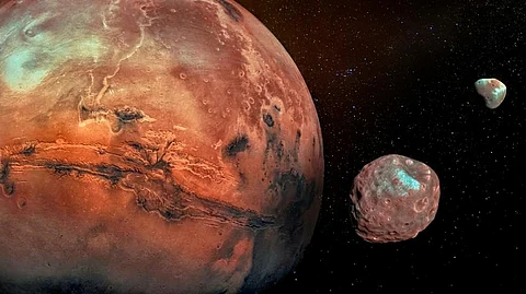 Mars with its two cratered moons Phobos and Deimos. Photo: iStock