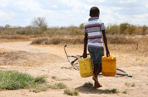 A boy carries water in one of Kenya’s arid regions that has been gripped by drought. Dong Jianghui/Xinhua via Getty Images