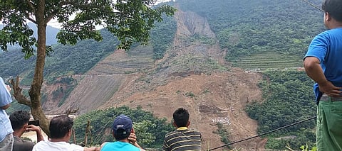 Onlookers observe search operations from National Highway 37 (Imphal-Silchar route) July 1, 2022. Photo: Sobhapati Samom