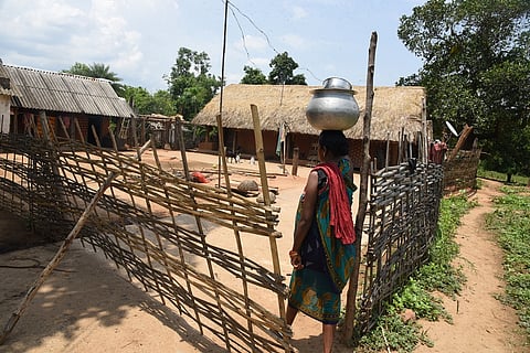 A woman carrying water to her home in Bidapaju village in Odisha’s Nayagarh district. Photo: Arabinda Mahapatra