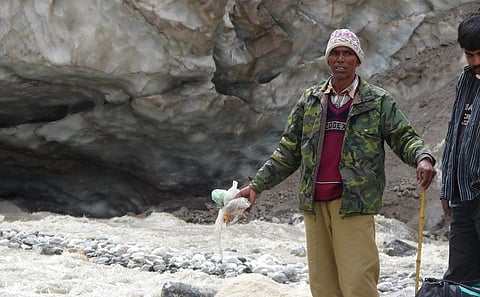 With the passage of time, humanity has eventually realised that they have been feeding a monster, which is now engulfing their planet itself. Here, a security guard gathers plastic at the Gaumukh glacier. Photo: Ravleen Kaur / CSE