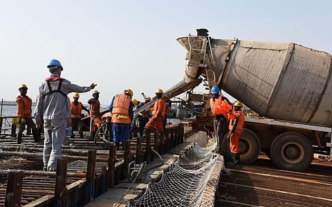Chinese and Ivorian workers at the site of a container terminal at the port of Abidjan. Photo: Issouf Sanogo / AFP via Getty Images