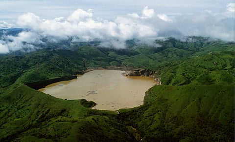 The waters of Lake Nyos, Cameroon, turn a murky brown following a deadly release of toxic gas. Photo: Thierry Orban / Sygma via Getty Images