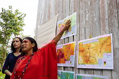 Maria Elena Paredes, coordinator of the Community Vigilance Committee for the Ashéninka community of Sawawo Hito 40, points to satellite images showing deforestation. Photo: Reynaldo Vela/USAID