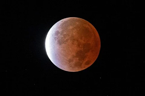 A nearly total, or 97%, eclipse of November’s full “Beaver Moon” captured over the city of New Orleans November 19, 2021. Photo: NASA