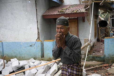 A man reacts as he inspects the damage caused by Monday’s earthquake in Cianjur, West Java, Indonesia. Photo: Tatan Syuflana/AP