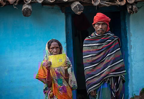 Anar Devi and her husband Sitaram Bhuiyan show their yellow ration card. They last received ration in December 2015. Photo: Vikas Choudhary