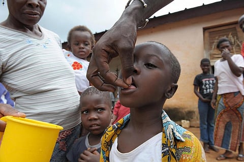 A nurse gives gives medicine, Ivermectin, against onchocerciasis or river blindness. Photo: Issouf Sanogo / AFP via Getty Images