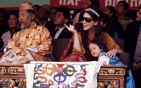 The 12th Chogyal (King) of Sikkim and his Gyalmo (Queen consort), Hope Cooke, with their daughter, Hope Leezum, watch birthday celebrations in Gangtok, Kingdom of Sikkim. Photo: Alice S Kandell via Wikimedia Commons