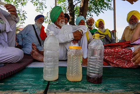 Villagers from around Zira show the polluted water samples they allegedly receive in their taps. Photo: Vikas Choudhary / CSE