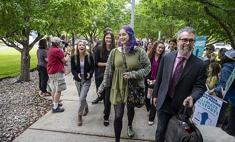 The young plaintiffs in Held v. State of Montana, ages 5 to 22, walk to the courthouse with their lawyer. William Campbell/Getty Images