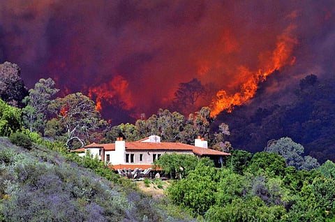 Homeowners and local governments can take steps to help protect homes from fires. Photo: AP Photo/Keith D Cullom