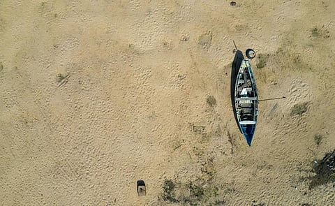 Small canoe stranded in the nearly dry bed of the Tapajos river in Alter do Chao, Santarem, Brazil, during the Amazonian drought in the second half of 2023. Photo: iStock