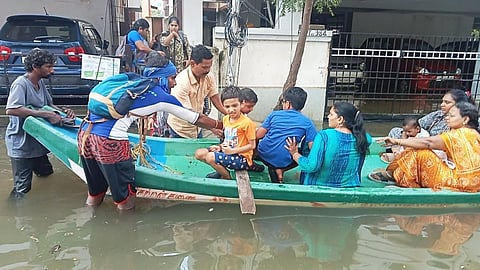 Women and children being ferried to safety in a flooded Chennai. Photo: @chennaipolice_ / X (formerly Twitter)